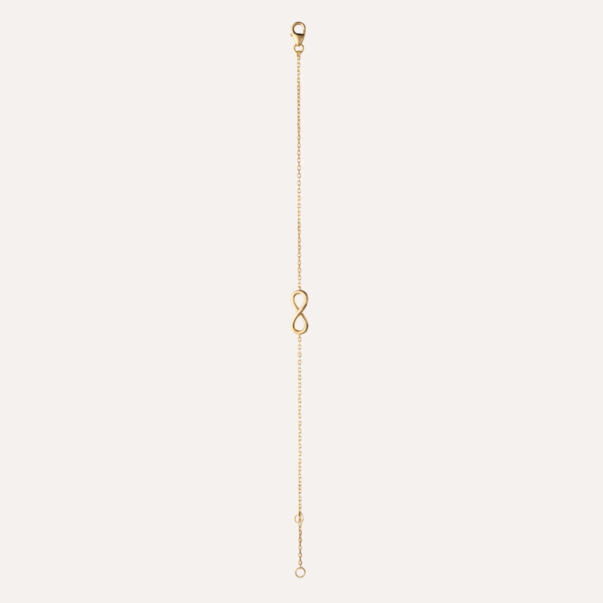 Bracelet chaîne fine plaqué or avec fermoir et symbole infini central