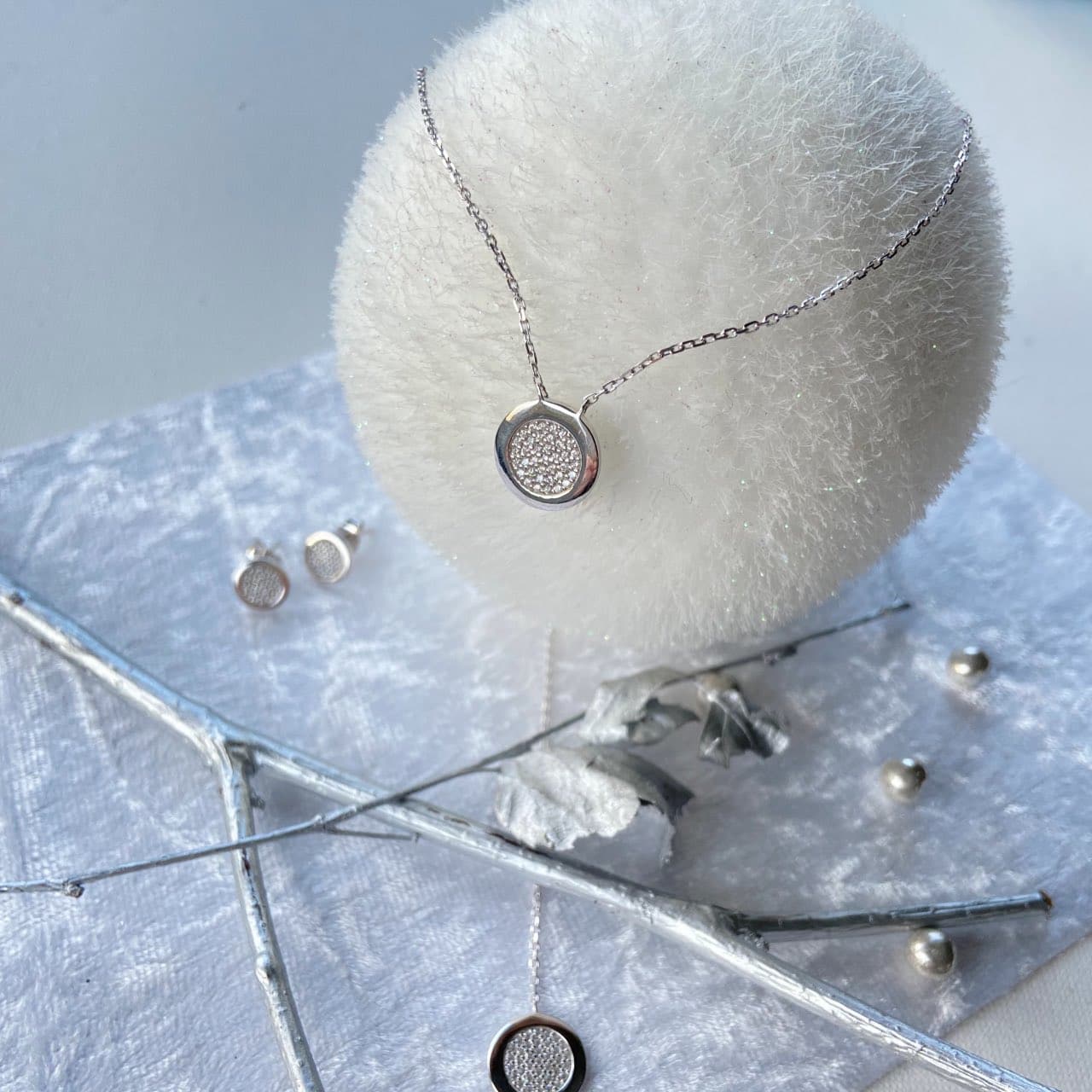 Gros plan collier zircons en argent sur une boule de Noël