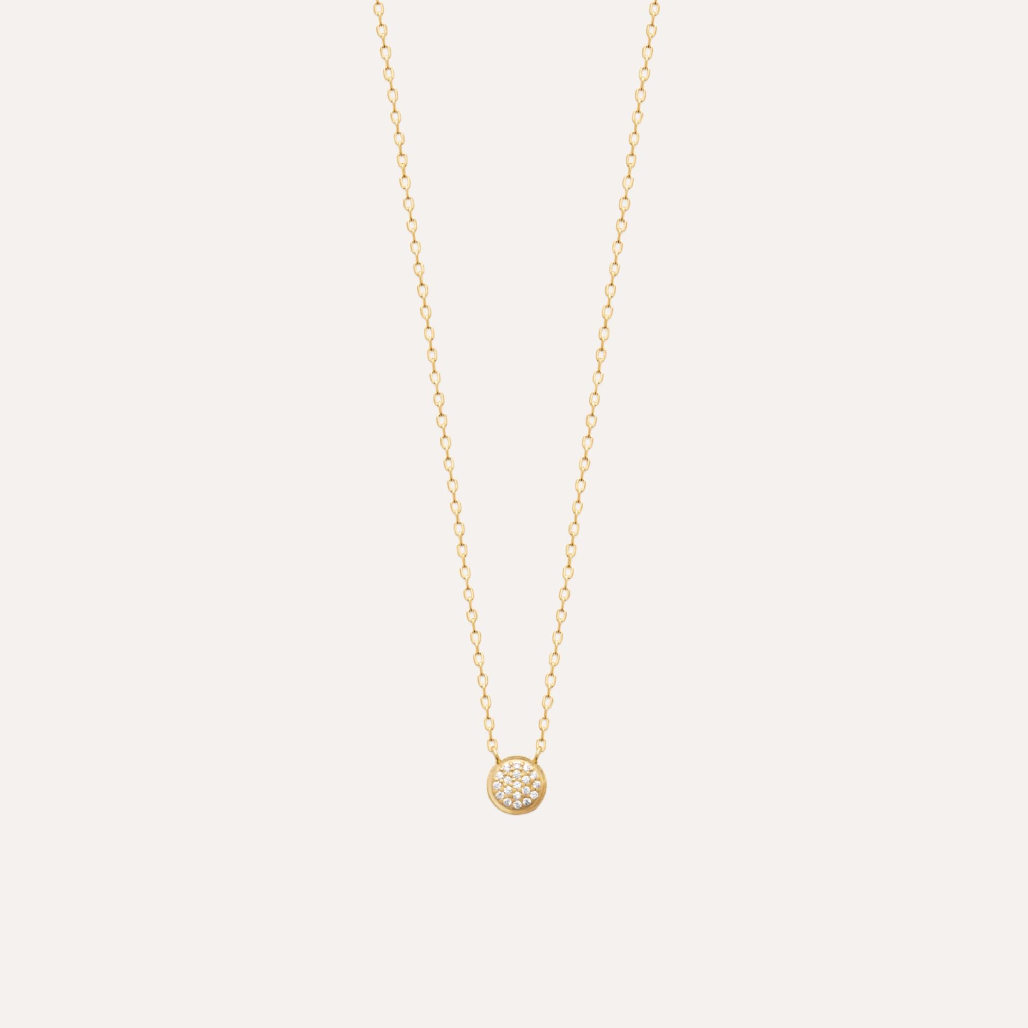 Collier femme fin en or avec pendentif rond pavé de pierres brillantes sur fond clair