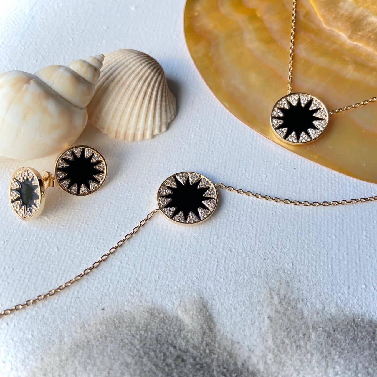 Bijoux pastille agate noire et zircon sur fond coquillage