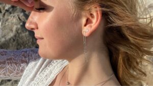 femme portant des boucles pendantes en argent